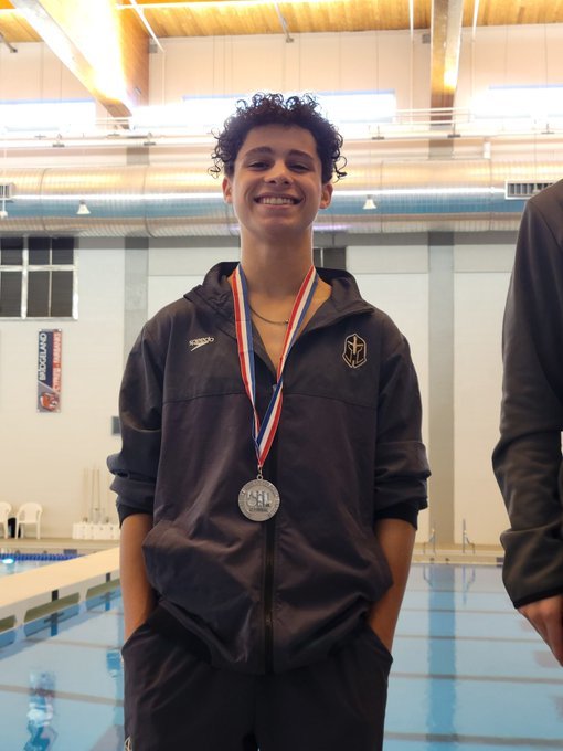 Jordan's Kaiden with his silver trophy for the 1-meter dive